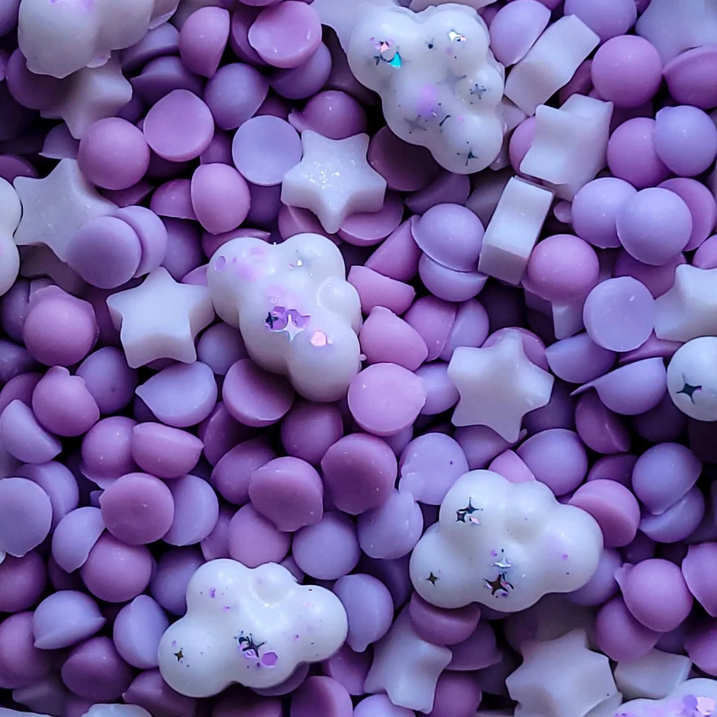 Tranquility Waxmelt in various purple and white shapes, including stars and clouds, from the Wellness Range.