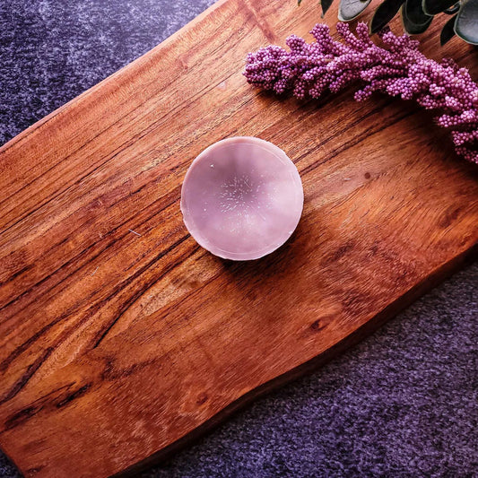 French Vanilla Bourbon Waxmelt on wooden tray with purple flowers, featuring vegan-friendly soy wax blend.