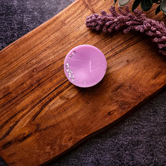 Tranquility Waxmelt with soothing lavender, cucumber, and sage on a wooden surface.