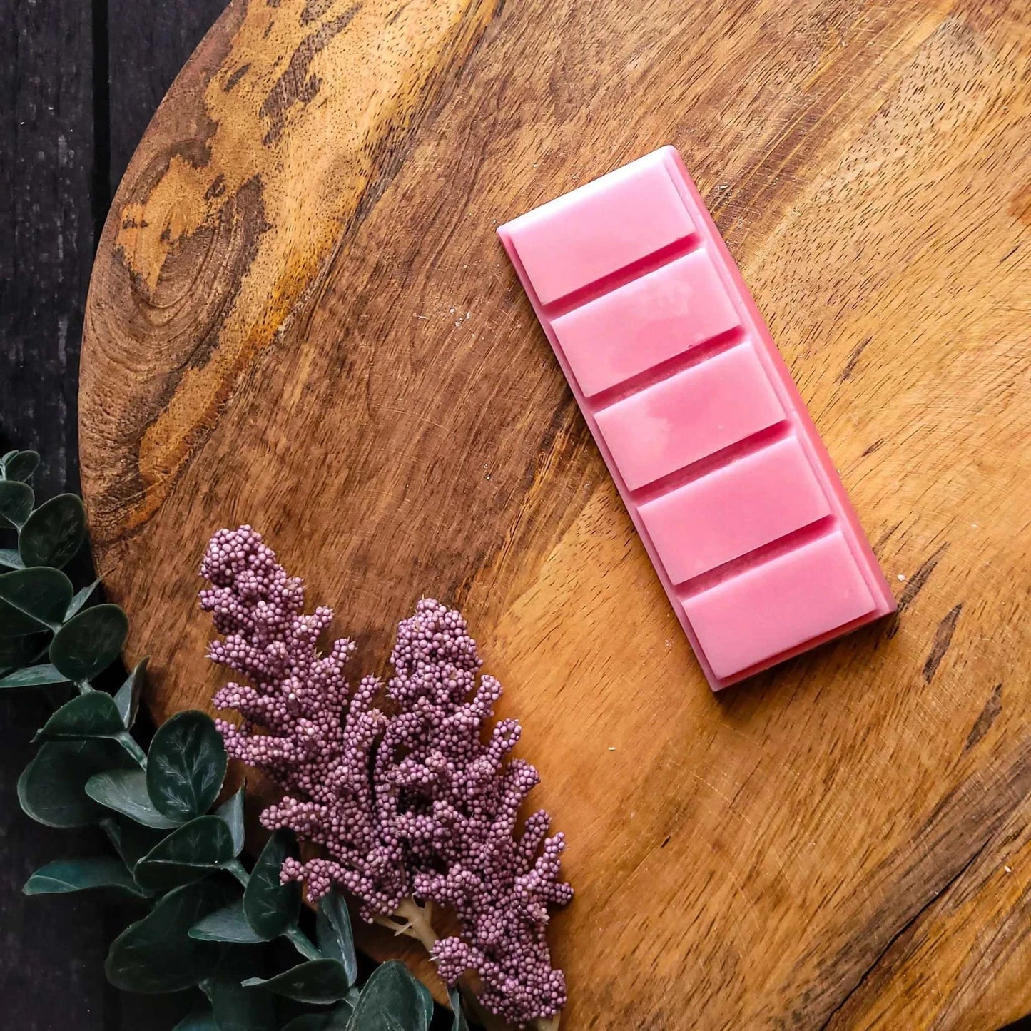 Watermelonade Waxmelt with vibrant pink snapbar on wooden background, vegan-friendly soy wax blend.