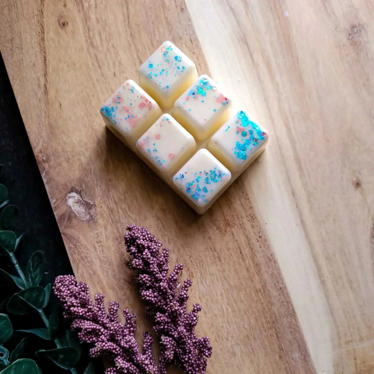 Vegan-friendly soy wax melts pack on wooden surface, reduced to clear.