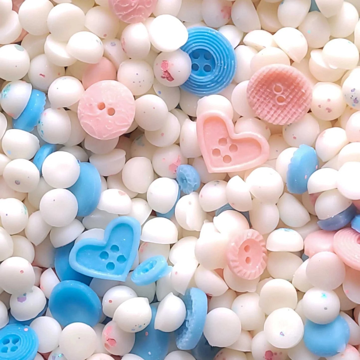 Crisp Cotton waxmelt with heart and button shapes in pastel colors, infused with green apple, cedar, and lavender scents.
