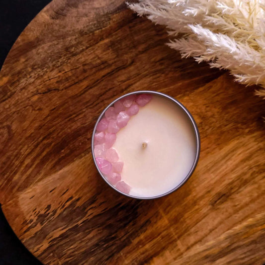 Dream Candle with lavender, mint, and cedarwood scents, surrounded by Rose Quartz crystals, on a wooden surface.