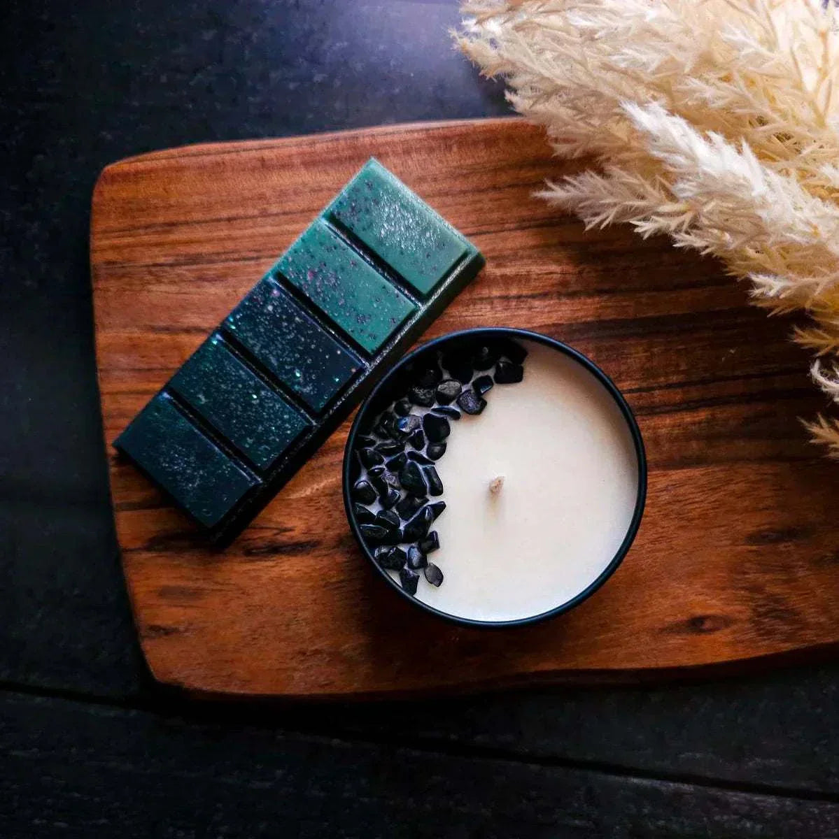 Wicked Collection Bundle featuring Elphaba-inspired candle with onyx crystals and matching snapbar on wooden board.