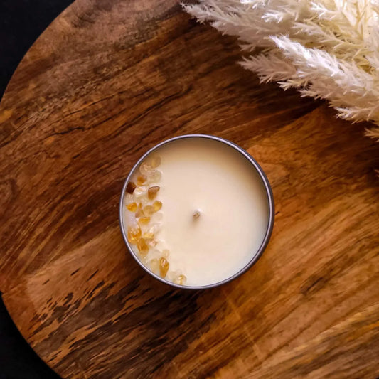 Gratitude Candle with citrine and coconut soy wax on wooden surface.