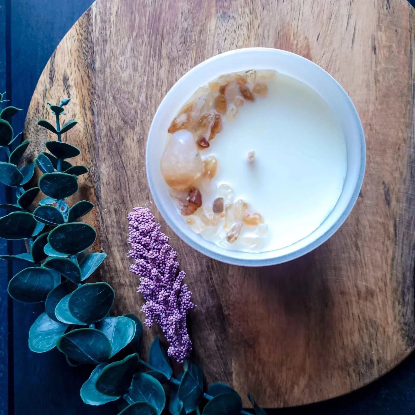 Gratitude Candle with mandarin, basil leaf, and jasmine aroma on wooden surface.