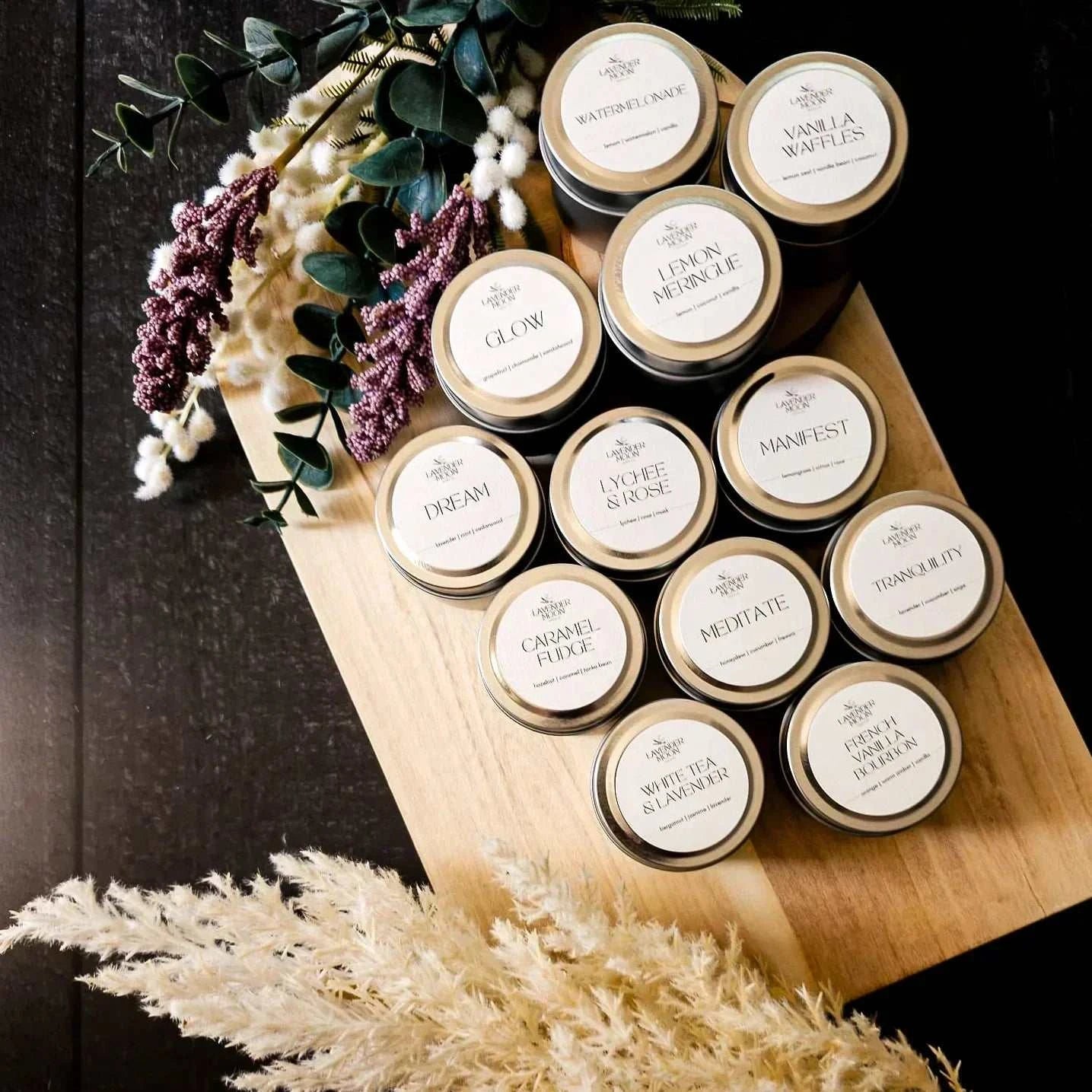 Lavender Moon 50g Candle Sampler with 12 scents on wooden board.