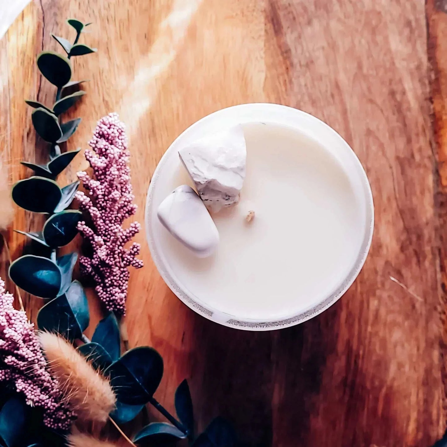 Meditate Candle with honeydew, cucumber, and freesia scent, featuring Rainbow Moonstone chips for balance; vegan-friendly coconut soy wax.