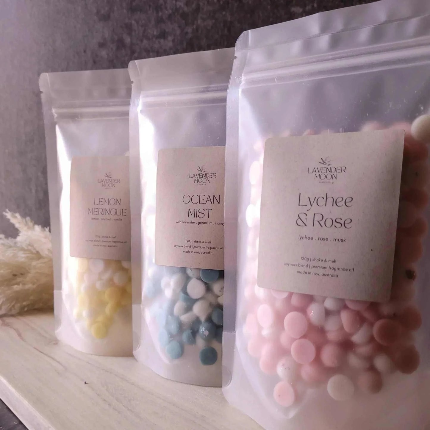Shake & Melt 3 Pack waxmelts in assorted scents on a wooden surface.