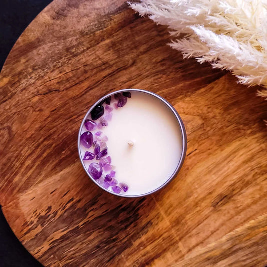 Tranquility Candle with amethyst crystals on wooden surface.