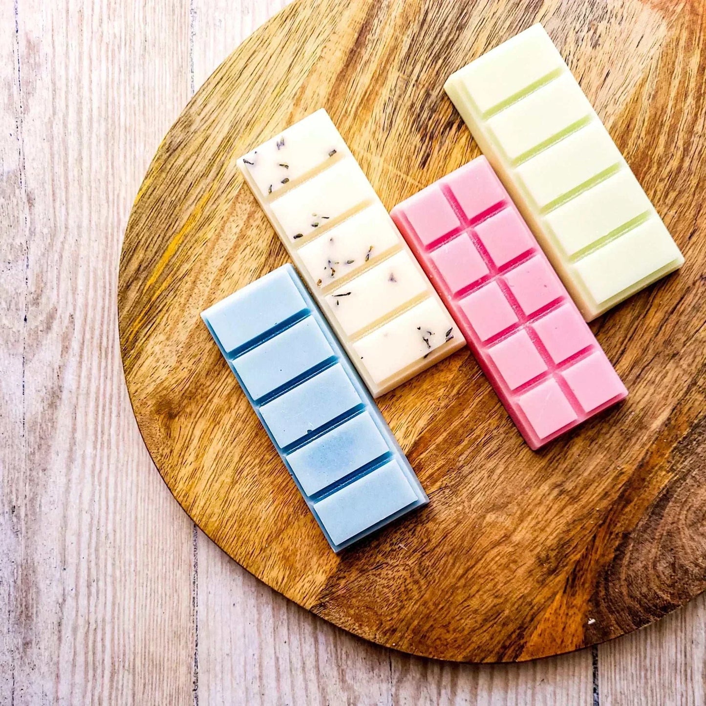 Lavender Moon 50g Snapbar 4 Pack on wooden board, featuring pink, blue, and cream bars, crafted from vegan-friendly soy wax blend with biodegradable glitter and botanicals.