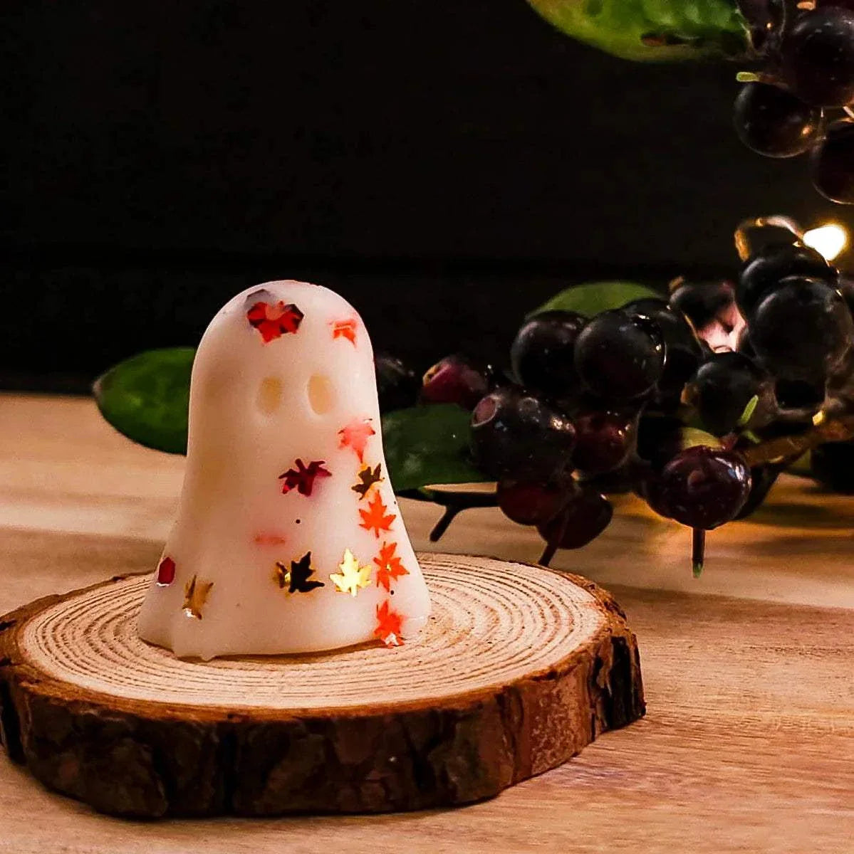 Tiny Ghost Melt on wooden base with autumn leaves design, made from soy wax.