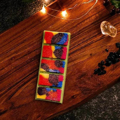 Lolly Bag Wax Melt with lime, pineapple, and vanilla aroma on a wooden surface.