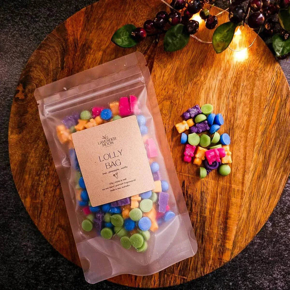 Lolly Bag Wax Melt with lime, pineapple, and vanilla aroma on a wooden surface. Vegan-friendly soy wax.
