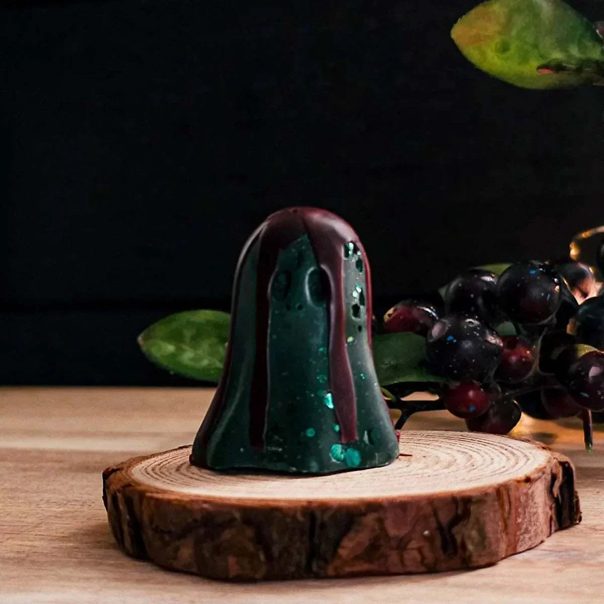 Tiny Ghost Melt figurine in Halloween scent on wooden stand.